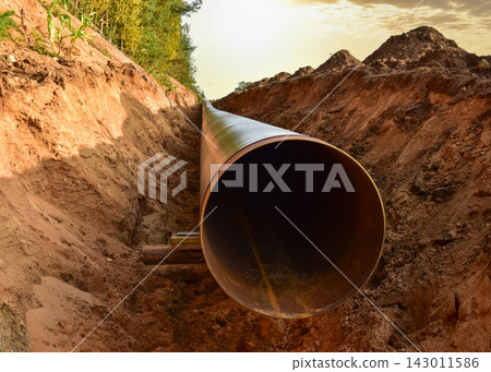 Pipeline Construction. Natural Gas Pipeline trench in ground on sunset. LNG, LPG. Oil and Gas Pipeline Construction. Natural Gas Pipeline trench in ground on sunset. LNG, LPG. Oil and Gas 143011586