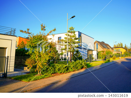 Landscape design features European-style landscaped lawn, ornamental conifers, 143011619