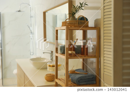 Shelving unit with toiletries in stylish bathroom interior Shelving unit with toiletries in stylish bathroom interior 143012041