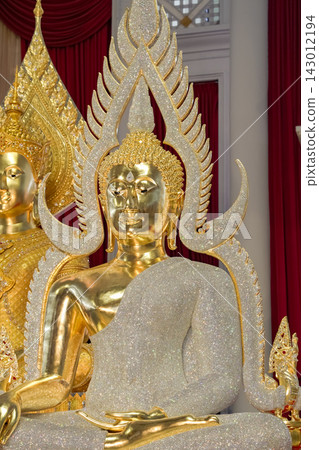 Ornate golden Buddha statue features diamond embellishments. The majestic deity radiates spiritual grace. Ornate golden Buddha statue features diamond embellishments. The majestic deity radiates spiritual grace. 143012194