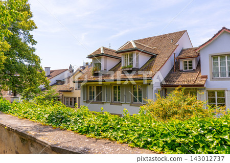 European Houses with Tiled Roofs, Dormer Windows and Lush Green. Old architecture. European Houses with Tiled Roofs, Dormer Windows and Lush Green. Old architecture. 143012737