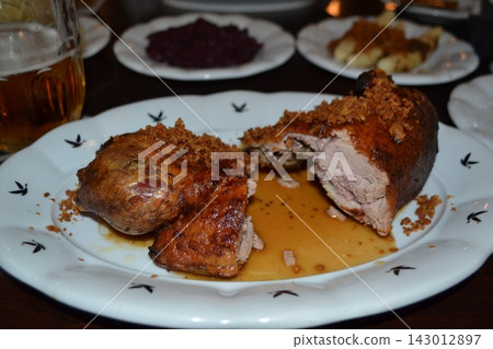 Traditional czech roasted duck detail with dumplings red cabbage and crispy crumbs for close food layout and menu background design Traditional czech roasted duck detail with dumplings red cabbage and crispy crumbs for close food layout and menu background design 143012897