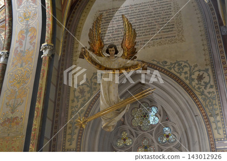 Basilica of St Peter and St Paul in Vysehrad, Prague. Gilded angel statue in basilica interior with stained glass and decorative mural for church background and historic architecture Basilica of St Peter and St Paul in Vysehrad, Prague. Gilded angel statue in basilica interior with stained glass and decorative mural for church background and historic architecture 143012926