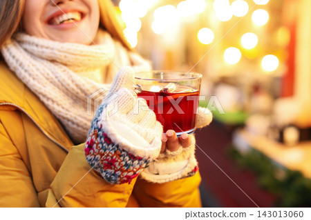 Woman with mulled wine at winter fair, closeup Woman with mulled wine at winter fair, closeup 143013060