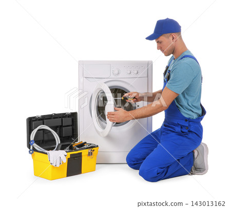 Plumber repairing washing machine on white background Plumber repairing washing machine on white background 143013162