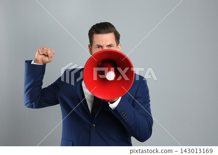 Handsome man with megaphone on grey background 143013169