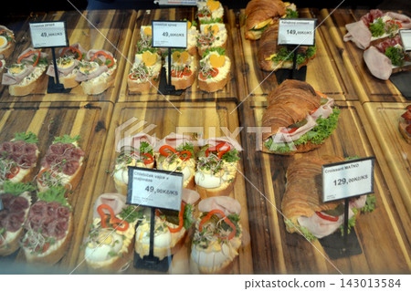 Colorful chlebicek open faced sandwich assortment in prague deli display with croissant and egg for menu background and food banner design Colorful chlebicek open faced sandwich assortment in prague deli display with croissant and egg for menu background and food banner design 143013584