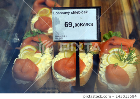 Salmon chlebicek open sandwich in a prague bar for menu background and food banner showcasing czech snack and display case Salmon chlebicek open sandwich in a prague bar for menu background and food banner showcasing czech snack and display case 143013594