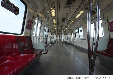Empty subway train car interior with red seats and bright windows 143013622