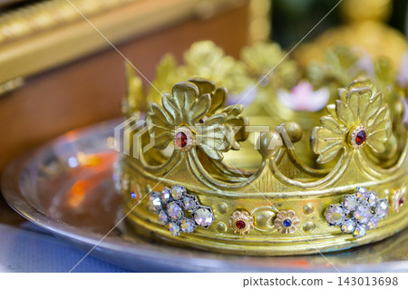 Wedding crowns placed on a silver platter during a ceremony at a church Wedding crowns placed on a silver platter during a ceremony at a church 143013698
