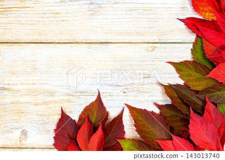 Autumn background. red ivy leaves on a wooden base. place for text. Autumn background. red ivy leaves on a wooden base. place for text. 143013740