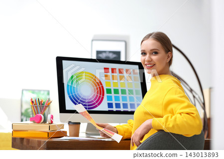 Professional designer with color palettes at workplace in office Professional designer with color palettes at workplace in office 143013893