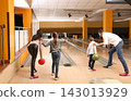Happy family spending time together in bowling club 143013929