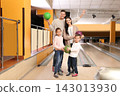 Happy family spending time together in bowling club 143013930