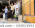 Happy family spending time together in bowling club 143013933