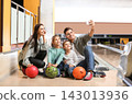 Happy family taking selfie in bowling club 143013936