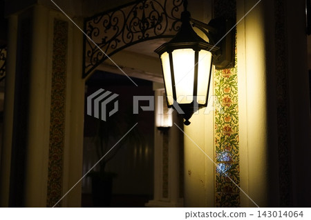 Elegant outdoor lantern illuminates decorative tiles Elegant outdoor lantern illuminates decorative tiles 143014064