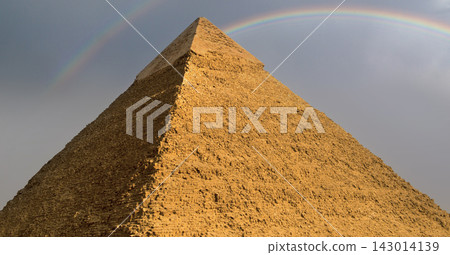 Ancient egyptian pyramid of Khafre rising under a rare double rainbow against a dramatic overcast sky in Giza a breathtaking landmark image ideal for Ancient egyptian pyramid of Khafre rising under a rare double rainbow against a dramatic overcast sky in Giza a breathtaking landmark image ideal for 143014139