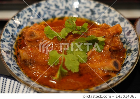 Delicious Spicy Pork Ribs in Rich Sauce with Fresh Cilantro Delicious Spicy Pork Ribs in Rich Sauce with Fresh Cilantro 143014363