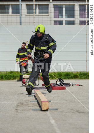 Firefighter Training Drill With Helmet, Hose And Obstacle Course During Emergency Preparedness Exercise Firefighter Training Drill With Helmet, Hose And Obstacle Course During Emergency Preparedness Exercise 143014481
