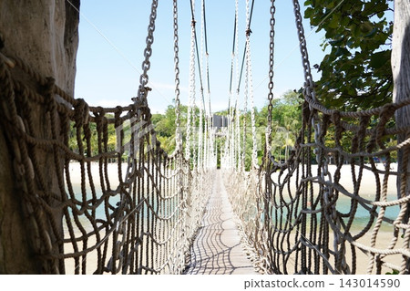 Scenic Rope Bridge Path Through Tropical Landscape Scenic Rope Bridge Path Through Tropical Landscape 143014590