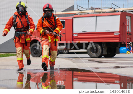 Firefighters Running to Emergency With Fire Truck and Protective Gear Reflected in Water Firefighters Running to Emergency With Fire Truck and Protective Gear Reflected in Water 143014628