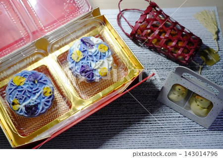 Artful Mooncakes with Edible Flower Decorations and Sweet Treats Artful Mooncakes with Edible Flower Decorations and Sweet Treats 143014796