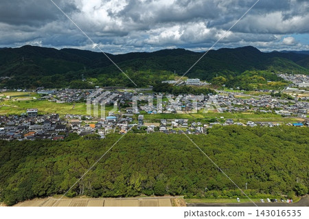 An aerial photograph capturing a residential area and mountain range in Kuroshio Town, Kochi Prefecture. An aerial photograph capturing a residential area and mountain range in Kuroshio Town, Kochi Prefecture. 143016535