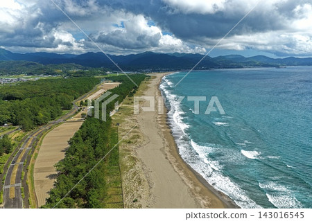 Aerial photograph of Irino Coast, pine forest, and village in Kuroshio Town, Kochi Prefecture. Aerial photograph of Irino Coast, pine forest, and village in Kuroshio Town, Kochi Prefecture. 143016545