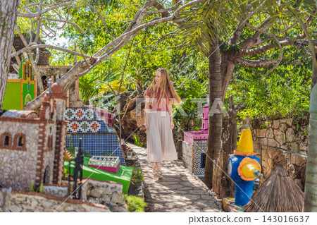 Woman tourist visiting traditional Mexican cemetery during Day of the Dead, walking among colorful graves and folk art in Mexico, cultural travel concept Woman tourist visiting traditional Mexican cemetery during Day of the Dead, walking among colorful graves and folk art in Mexico, cultural travel concept 143016637