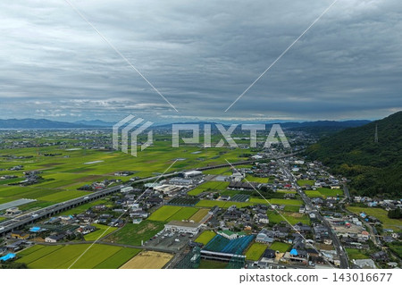 Aerial photograph capturing rice paddies and residential areas in Yatsushiro City, Kumamoto Prefecture. Aerial photograph capturing rice paddies and residential areas in Yatsushiro City, Kumamoto Prefecture. 143016677