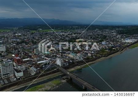 Aerial photograph capturing the city center, river, and bridges of Hitoyoshi City, Kumamoto Prefecture. Aerial photograph capturing the city center, river, and bridges of Hitoyoshi City, Kumamoto Prefecture. 143016697