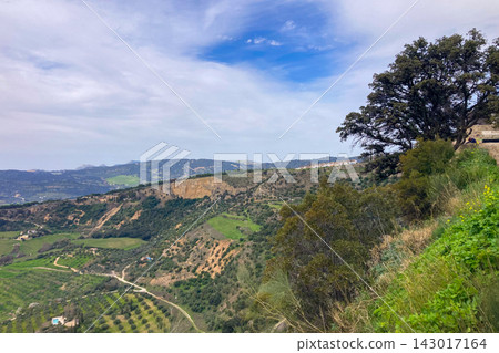 Panoramic view of surrounding landscapes and mountains from scenic elevated viewpoint in Ronda, Spain. Panoramic view of surrounding landscapes and mountains from scenic elevated viewpoint in Ronda, Spain. 143017164