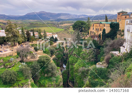 Panoramic view of surrounding landscapes and mountains from scenic elevated viewpoint in Ronda, Spain. Panoramic view of surrounding landscapes and mountains from scenic elevated viewpoint in Ronda, Spain. 143017168