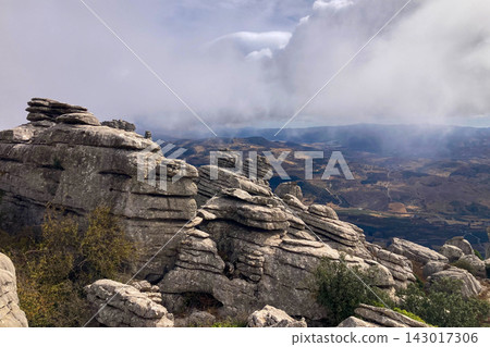 A mystical morning walk through the rocky landscapes of Torcal de Antequera in Andalusia, Spain, as soft mist drifts under the gentle rays of the sun. A mystical morning walk through the rocky landscapes of Torcal de Antequera in Andalusia, Spain, as soft mist drifts under the gentle rays of the sun. 143017306