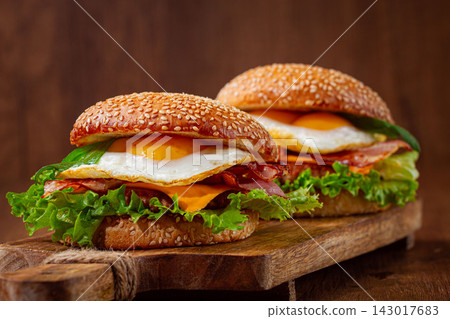 burgers with eggs, cheese and herbs, served on a wooden board, homemade, no people, burgers with eggs, cheese and herbs, served on a wooden board, homemade, no people, 143017683