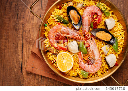 Seafood paella, in a frying pan, on a wooden table, no people, Seafood paella, in a frying pan, on a wooden table, no people, 143017718