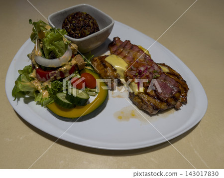 top view grilled chicken, bacon, a side salad, and riceberry, served on a large white oval plate on brown and cream marble floor background, food, fresh, copy space top view grilled chicken, bacon, a side salad, and riceberry, served on a large white oval plate on brown and cream marble floor background, food, fresh, copy space 143017830
