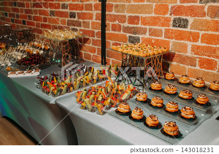 Elegant buffet of assorted canapes and appetizers for a catered event Elegant buffet of assorted canapes and appetizers for a catered event 143018231