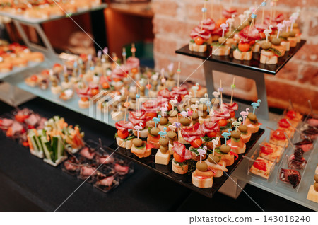 Assorted gourmet appetizers and canapes at a festive event Assorted gourmet appetizers and canapes at a festive event 143018240