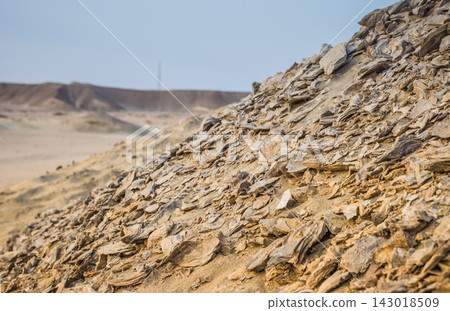 Rocky hill with layered stones in a dry desert landscape Rocky hill with layered stones in a dry desert landscape 143018509