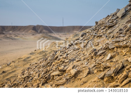 Sloping mound of fractured rock and earth in arid desert terrain Sloping mound of fractured rock and earth in arid desert terrain 143018510
