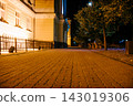 The tiled road in the night green park with lanterns and buildings in summer. Benches in the park during the summer season at night. Illumination of a park road with lanterns. Ukraine 143019306