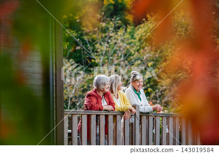 Portrait of three smiling senior women together outdoors. Portrait of three smiling senior women together outdoors. 143019584