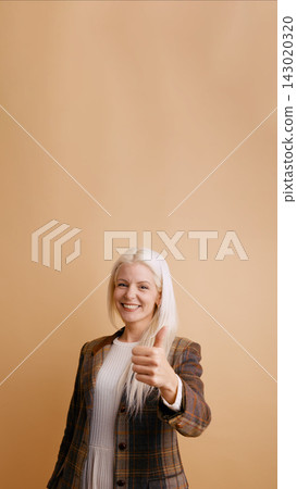 Adult woman giving thumbs up approving gesture Adult woman giving thumbs up approving gesture 143020320