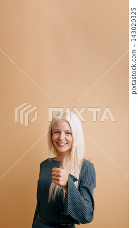 Young woman giving thumbs up approving good result Young woman giving thumbs up approving good result 143020325