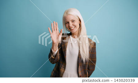 Blonde woman waving hand greeting hello Blonde woman waving hand greeting hello 143020339