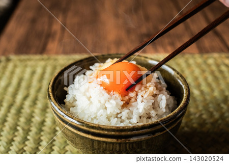 Freshly cooked rice topped with a rich egg yolk. Freshly cooked rice topped with a rich egg yolk. 143020524