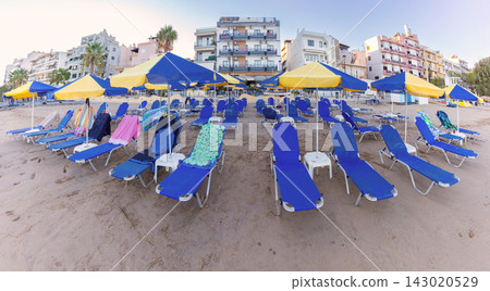 Sun Loungers and Umbrellas on Sandy Beach in Chania, Crete, Greece 143020529