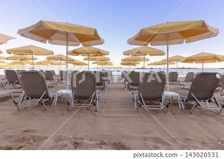 Sun Loungers and Umbrellas on Sandy Beach in Chania, Crete, Greece Sun Loungers and Umbrellas on Sandy Beach in Chania, Crete, Greece 143020531